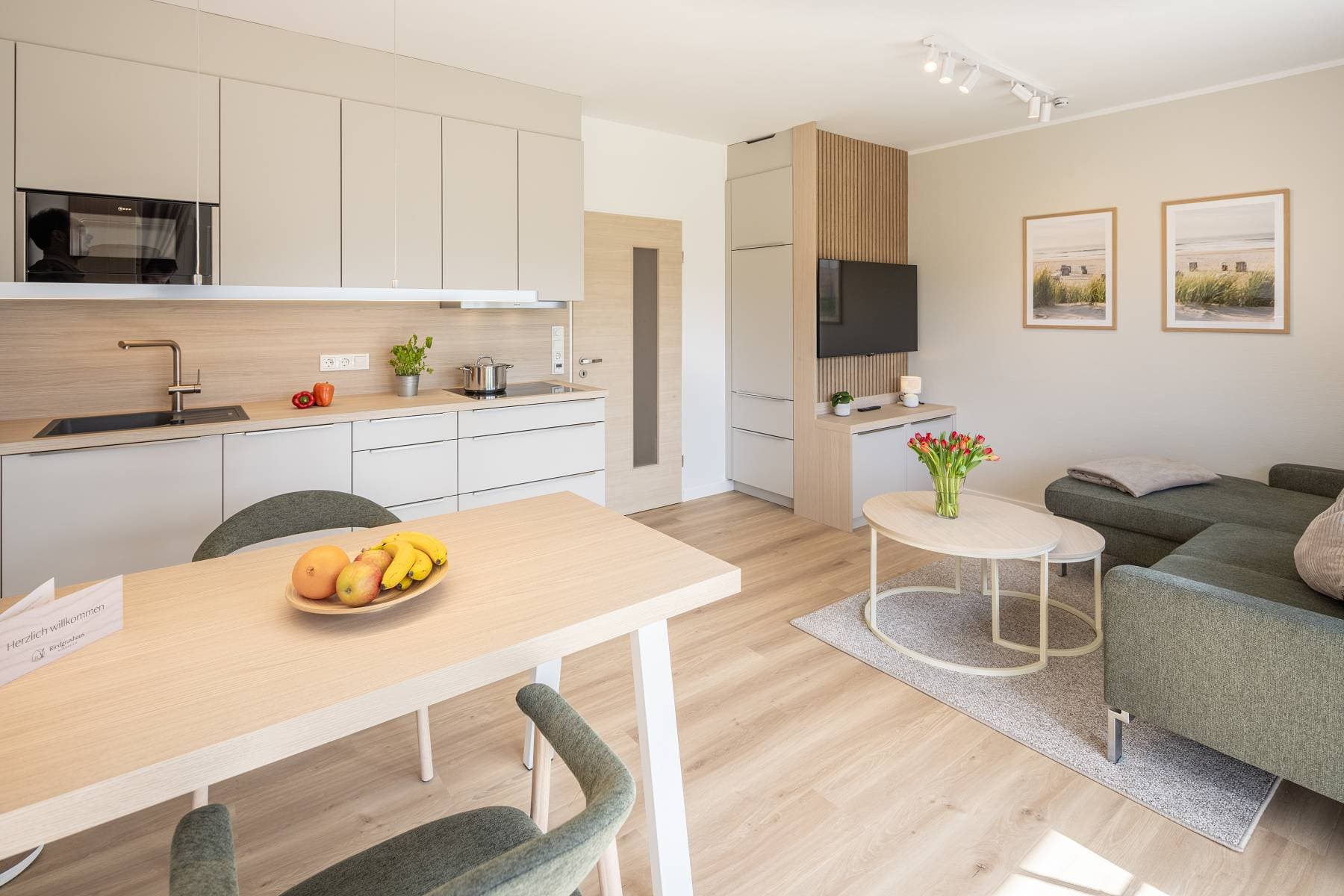 Ferienwohnung Riedgras 3 – Offener Wohnbereich mit Esstisch, Küchenzeile und Smart-TV
